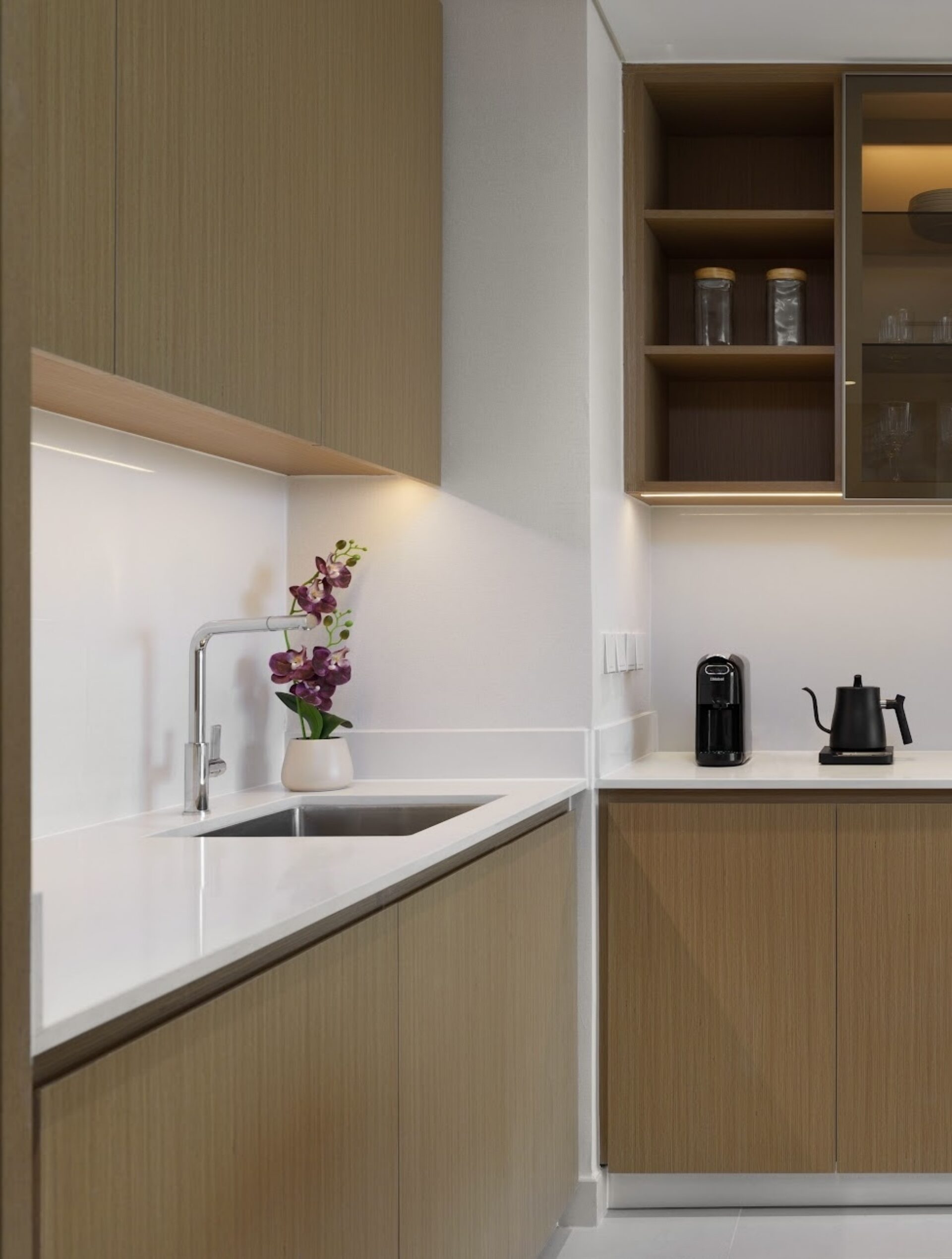 Kitchen in a property prepared by EAP, with oak cabinets, a white worktop, kettle and coffee machine