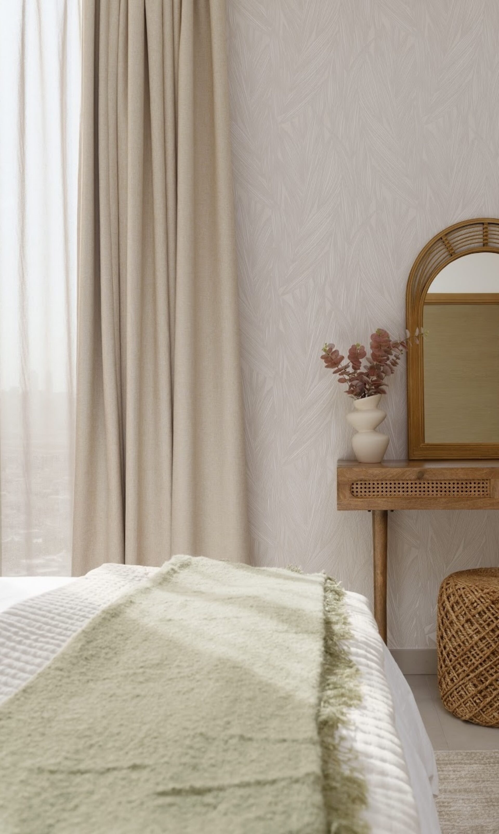 Bedroom in a property prepared by EAP, with a rattan dressing table, arched mirror and dried flowers